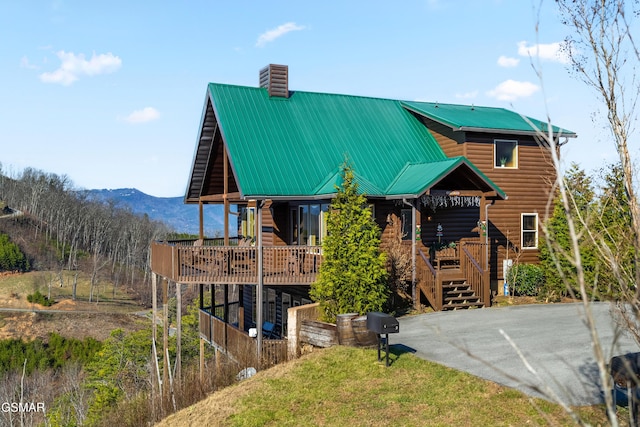 exterior space with a deck with mountain view