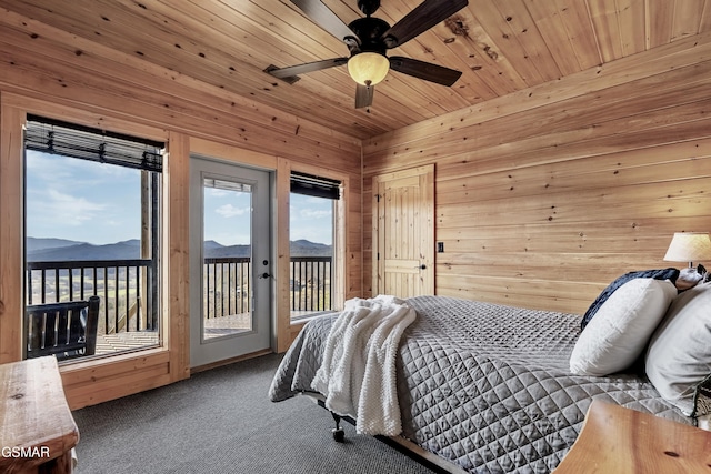 bedroom featuring ceiling fan, carpet floors, a mountain view, access to outside, and wooden ceiling