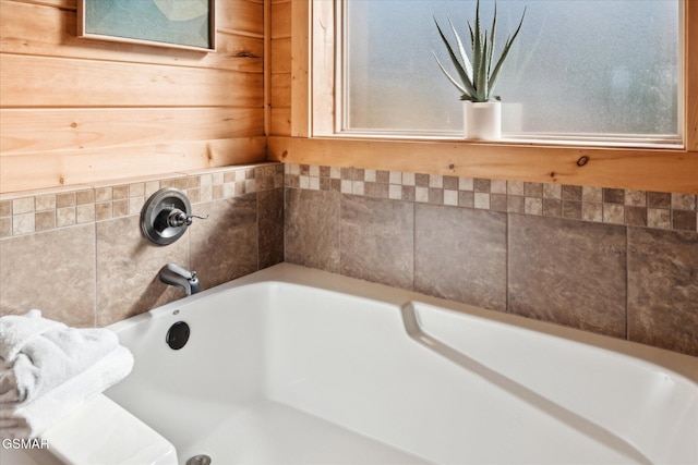 bathroom featuring a washtub and a wealth of natural light