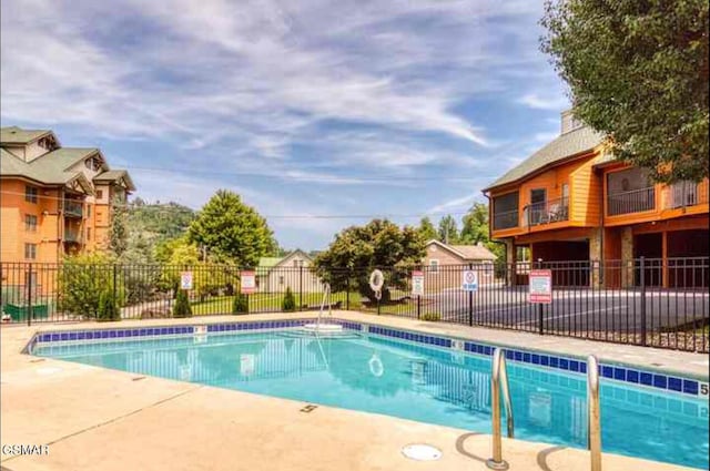 community pool featuring fence