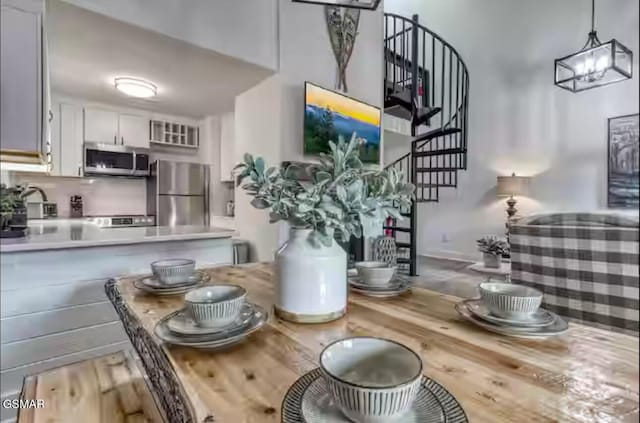 dining room featuring stairs