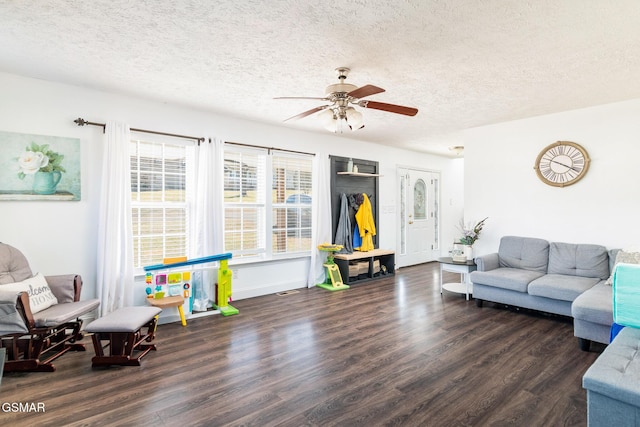 living area featuring a ceiling fan, a textured ceiling, and wood finished floors