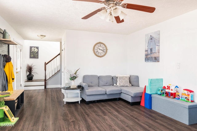 living room featuring stairs, ceiling fan, a textured ceiling, and wood finished floors