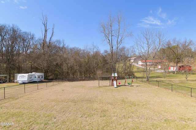 view of yard featuring playground community and fence private yard