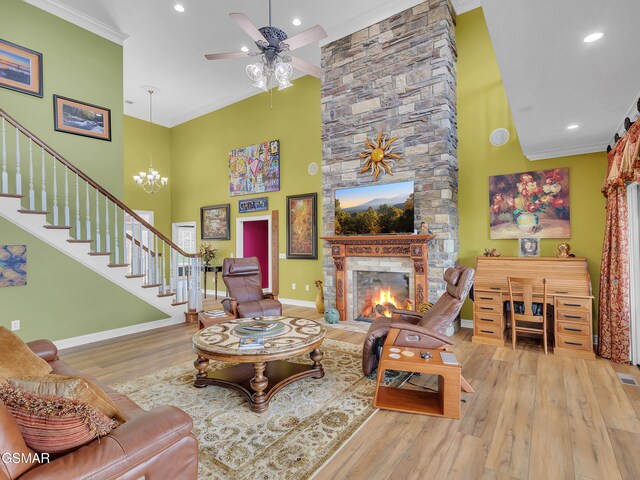 498 Proffitt Ridge Rd, Mooresburg, TN 37811 - living area featuring a high ceiling, wood finished floors, a stone fireplace, ceiling fan, and stairway