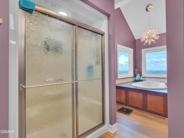 498 Proffitt Ridge Rd, Mooresburg, TN 37811 - full bath featuring hardwood / wood-style flooring, a bath, a stall shower, lofted ceiling, and a chandelier