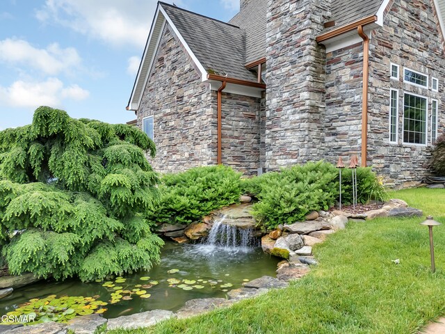 498 Proffitt Ridge Rd, Mooresburg, TN 37811 - view of side of property with a small pond, stone siding, and a shingled roof
