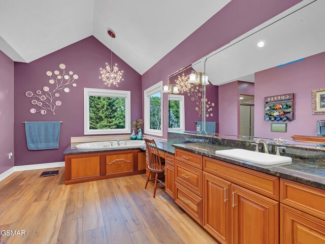 498 Proffitt Ridge Rd, Mooresburg, TN 37811 - full bath featuring a chandelier, vanity, wood finished floors, vaulted ceiling, and a bath