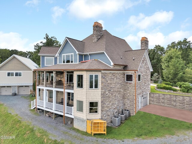 498 Proffitt Ridge Rd, Mooresburg, TN 37811 - back of house featuring a chimney, a balcony, roof with shingles, stone siding, and a garage