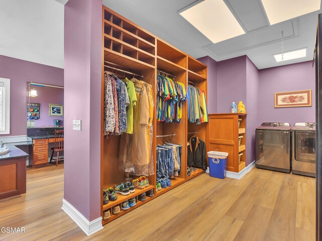 498 Proffitt Ridge Rd, Mooresburg, TN 37811 - walk in closet featuring washing machine and dryer, light wood-style flooring, and built in desk
