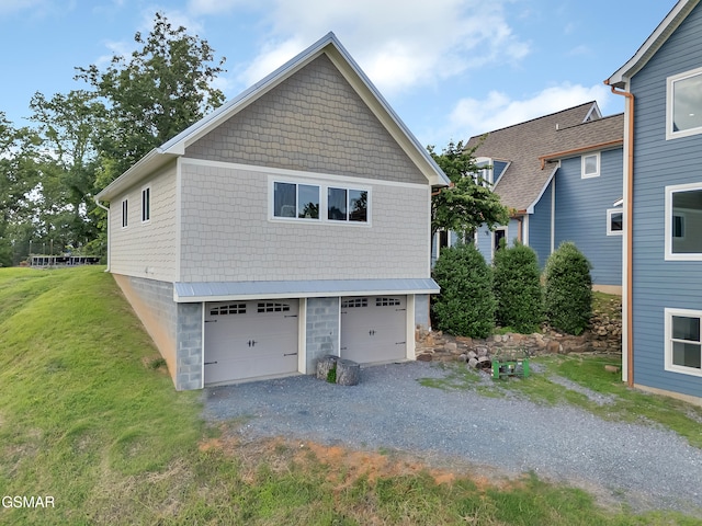 498 Proffitt Ridge Rd, Mooresburg, TN 37811 - view of side of home featuring gravel driveway, a lawn, and a garage