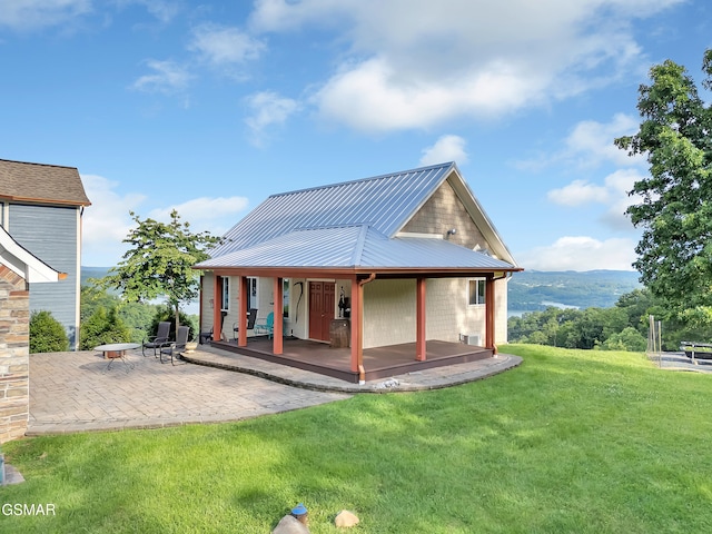 498 Proffitt Ridge Rd, Mooresburg, TN 37811 - rear view of property with a yard, a patio area, and a metal roof
