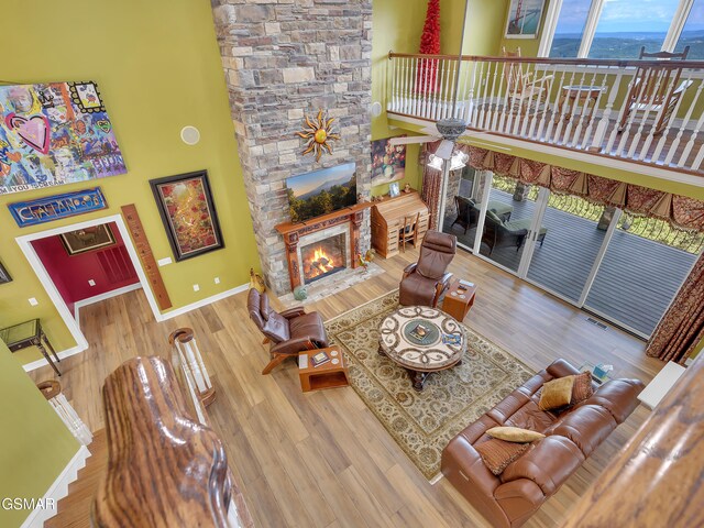 498 Proffitt Ridge Rd, Mooresburg, TN 37811 - living area with a stone fireplace, wood finished floors, and a high ceiling