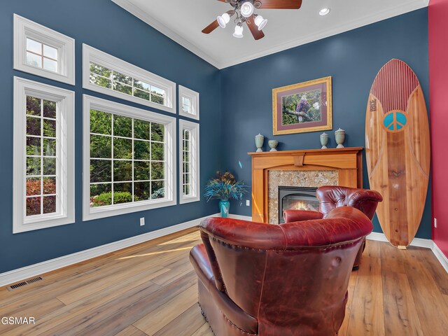 498 Proffitt Ridge Rd, Mooresburg, TN 37811 - living area featuring hardwood / wood-style flooring, plenty of natural light, a ceiling fan, crown molding, and a fireplace
