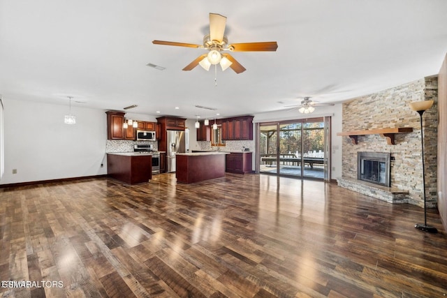 living room featuring a fireplace, ceiling fan, and dark hardwood / wood-style floors