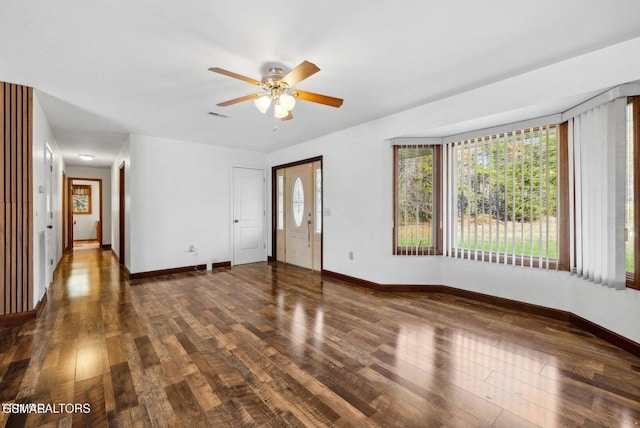 spare room featuring ceiling fan and dark hardwood / wood-style flooring