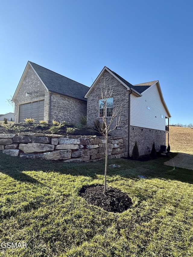 view of home's exterior with a lawn and a garage