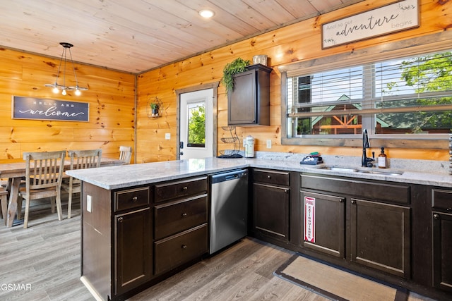 kitchen featuring stainless steel dishwasher, a sink, a peninsula, light wood-style flooring, and wood ceiling