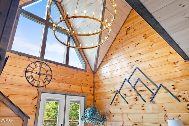 detailed view of wood walls, a chandelier, shuffleboard, and beamed ceiling