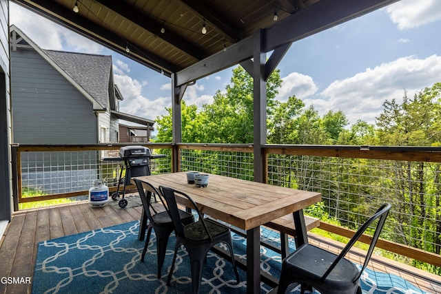 deck with outdoor dining area and area for grilling