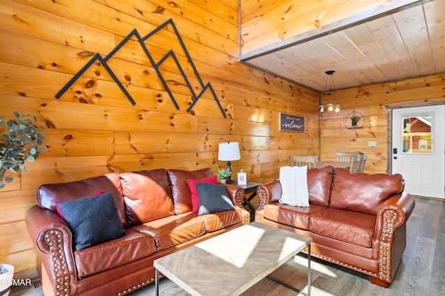 living room with wooden walls, wood finished floors, and wood ceiling