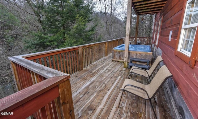 wooden deck featuring a hot tub