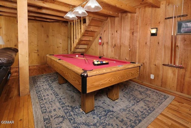 rec room featuring beamed ceiling, hardwood / wood-style flooring, wooden walls, and pool table