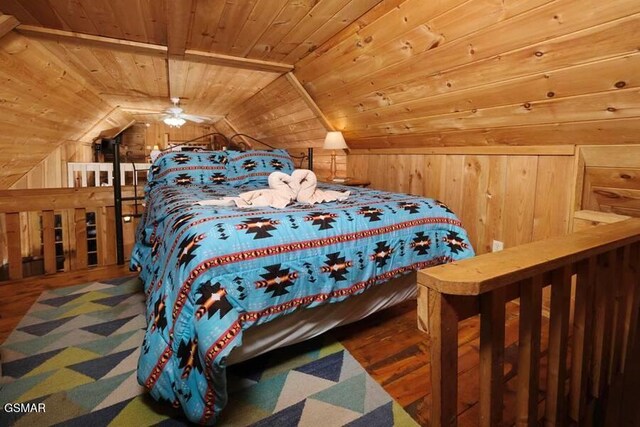 bedroom with wooden ceiling, wooden walls, and vaulted ceiling