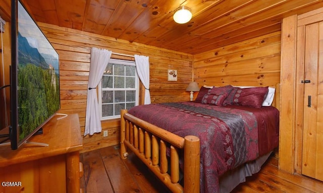 bedroom with wood-type flooring and wooden ceiling