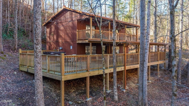 rear view of property featuring a wooden deck