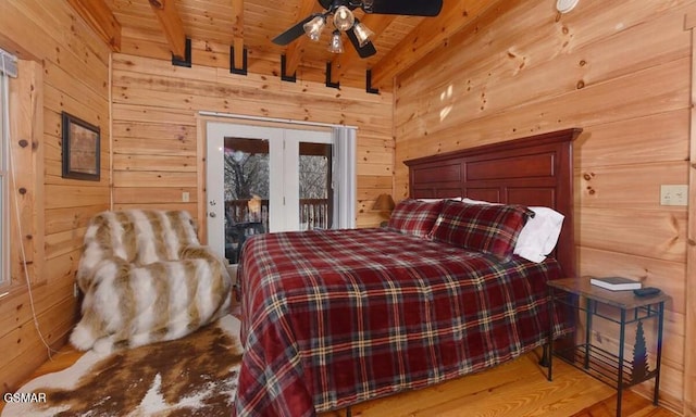 bedroom with wooden ceiling, beamed ceiling, wood walls, access to outside, and light wood-type flooring