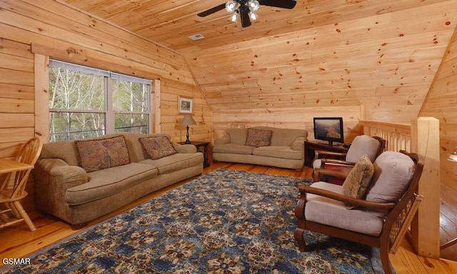 living room with wooden walls, hardwood / wood-style flooring, and wooden ceiling