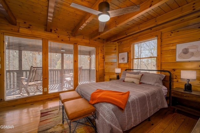 3214 Bear Country Way, Sevierville, TN 37876 - bedroom with beam ceiling, wooden walls, wooden ceiling, hardwood / wood-style floors, and access to outside