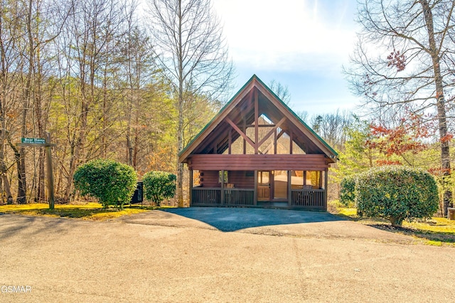 view of front of home with log siding and aphalt driveway