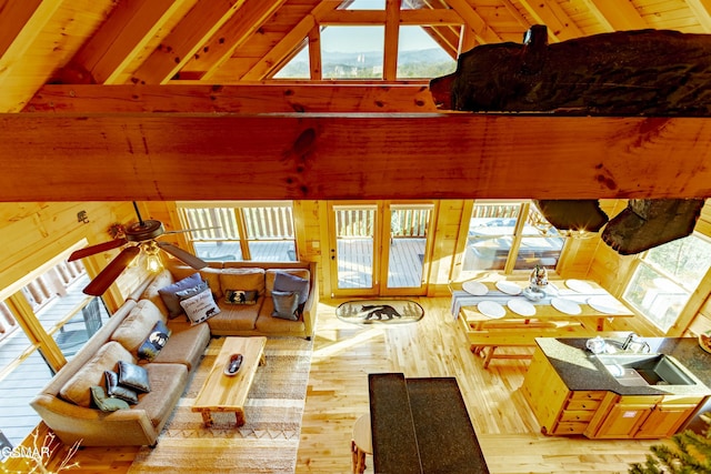 living room featuring ceiling fan, high vaulted ceiling, wood ceiling, and hardwood / wood-style floors