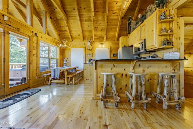 kitchen featuring open shelves, lofted ceiling with beams, dark countertops, stainless steel appliances, and wooden ceiling