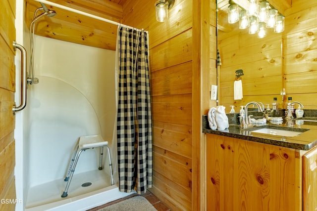 bathroom with vanity, wooden walls, and a shower stall