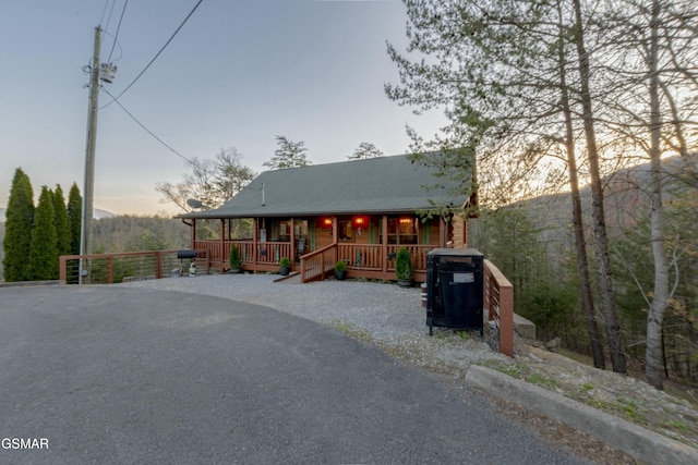 chalet / cabin featuring covered porch