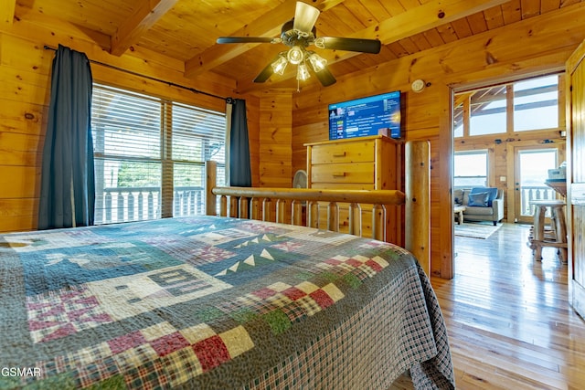 bedroom with beamed ceiling, wood walls, wooden ceiling, and light wood-style flooring