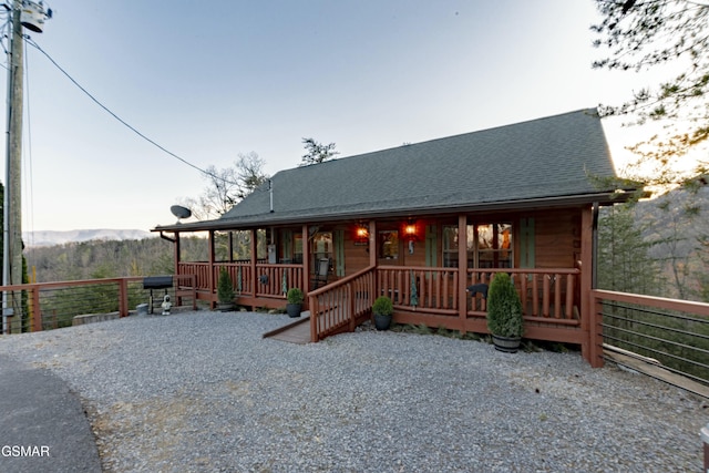 chalet / cabin with a shingled roof