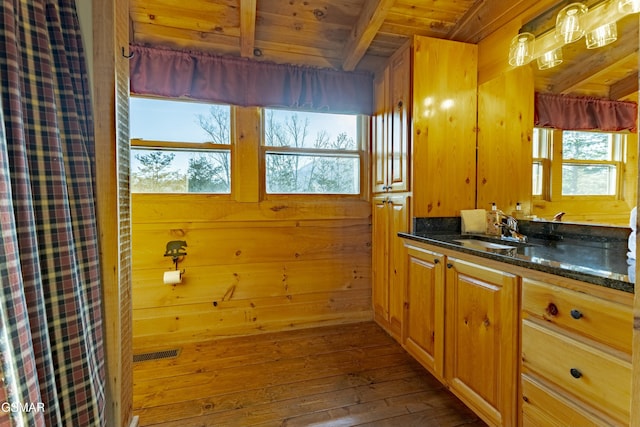 bathroom featuring a wealth of natural light, beamed ceiling, visible vents, hardwood / wood-style flooring, and wooden ceiling