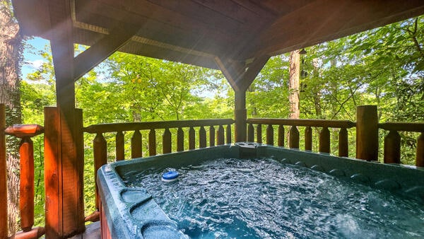 deck featuring a hot tub