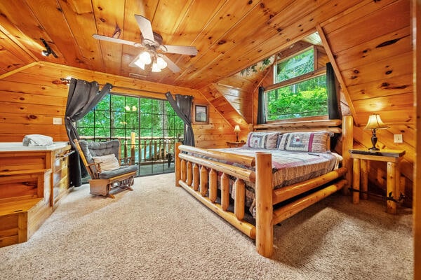 bedroom featuring lofted ceiling, multiple windows, and wooden ceiling