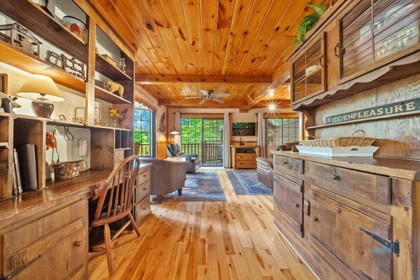 home office featuring wood ceiling, ceiling fan, light hardwood / wood-style floors, and beam ceiling