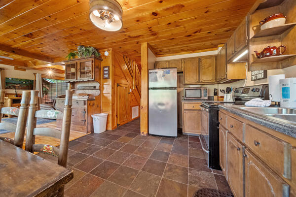 kitchen with wooden ceiling and appliances with stainless steel finishes