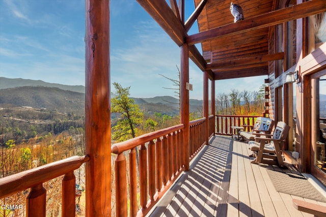 wooden deck with a mountain view