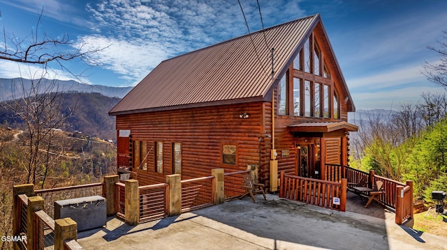 view of front of home featuring a mountain view and metal roof