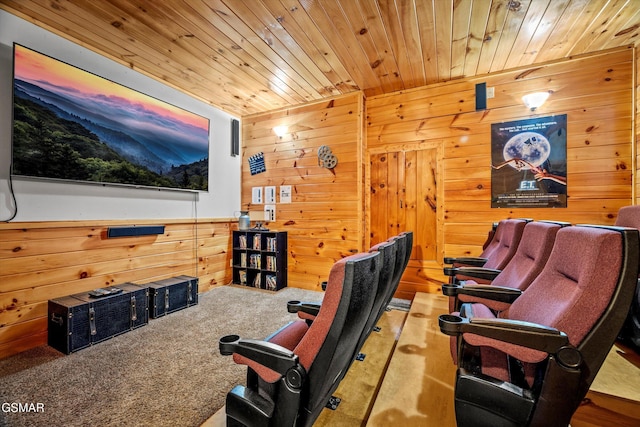 home theater room with wooden ceiling, carpet flooring, and wood walls