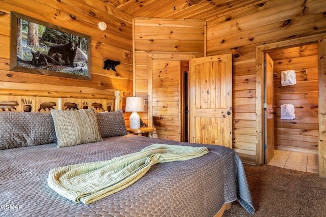 carpeted bedroom featuring tile patterned flooring and wooden walls