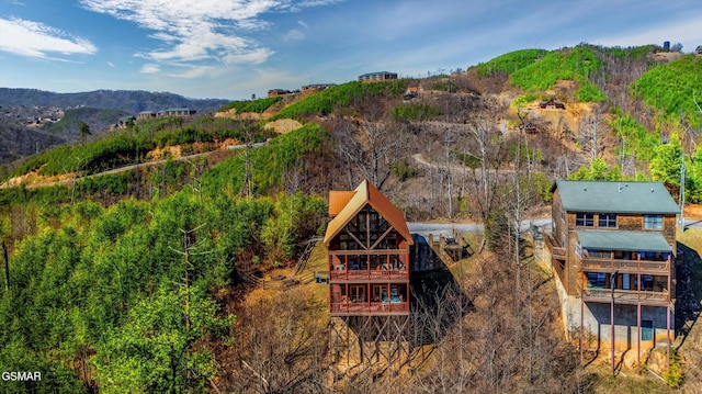 exterior space featuring a wooded view